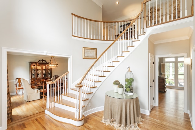 stairway featuring a high ceiling and light wood-type flooring