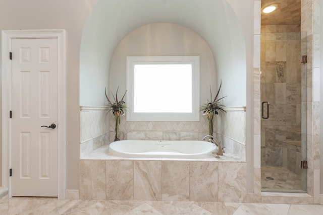 bathroom with tile floors and independent shower and bath