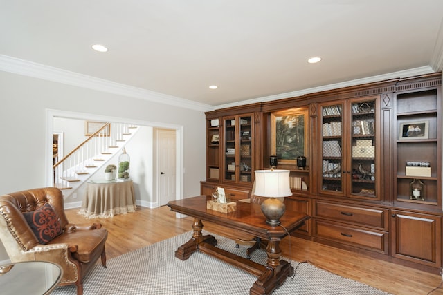 office space featuring light hardwood / wood-style flooring and crown molding