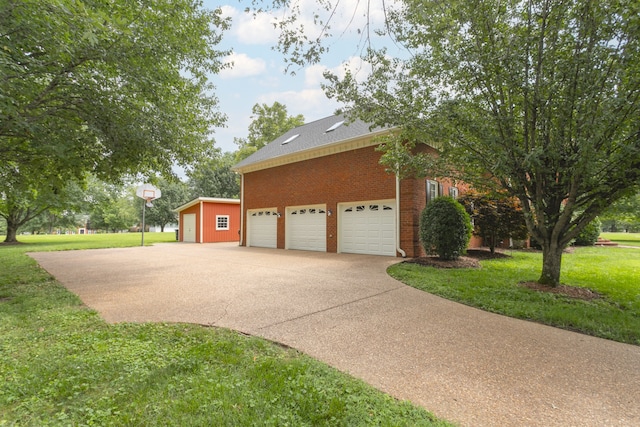 exterior space with an outdoor structure, a front lawn, and a garage