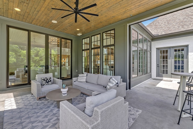 sunroom featuring french doors, ceiling fan, and wooden ceiling