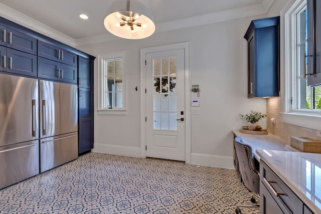 interior space featuring backsplash, blue cabinetry, stainless steel refrigerator, and light tile flooring