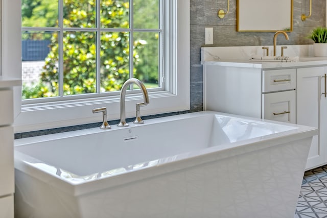 bathroom with tile walls, tile floors, a bath, and oversized vanity