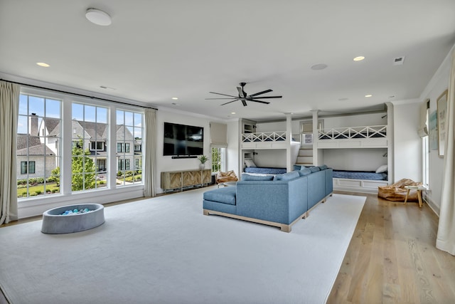 living room with ceiling fan and light hardwood / wood-style floors