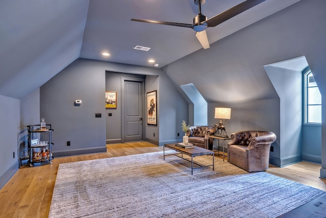 living area featuring ceiling fan, lofted ceiling, and light wood-type flooring