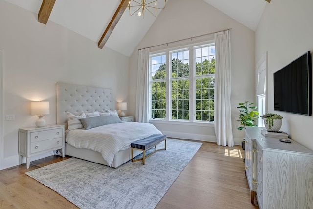 bedroom with a chandelier, high vaulted ceiling, light wood-type flooring, and beamed ceiling