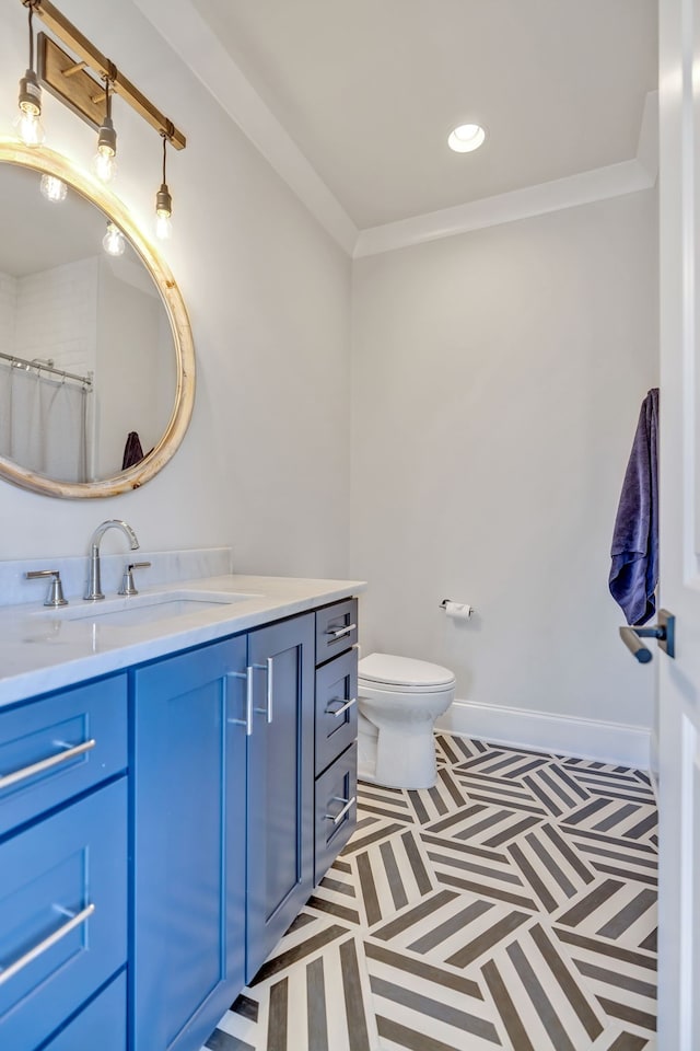 bathroom with tile floors, oversized vanity, toilet, and ornamental molding