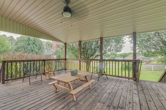 wooden terrace featuring a yard