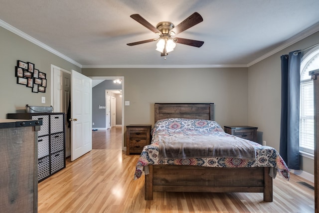 bedroom featuring ceiling fan, light wood-type flooring, and ornamental molding