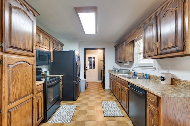 kitchen featuring sink, black appliances, and light tile floors