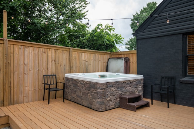 wooden terrace featuring a hot tub