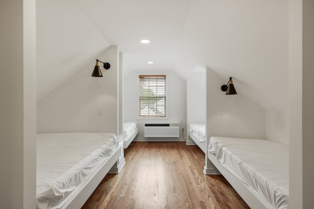 bedroom featuring dark wood-type flooring and vaulted ceiling