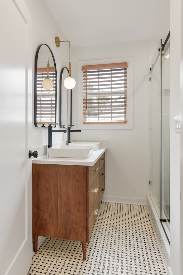 bathroom featuring tile flooring, walk in shower, and vanity