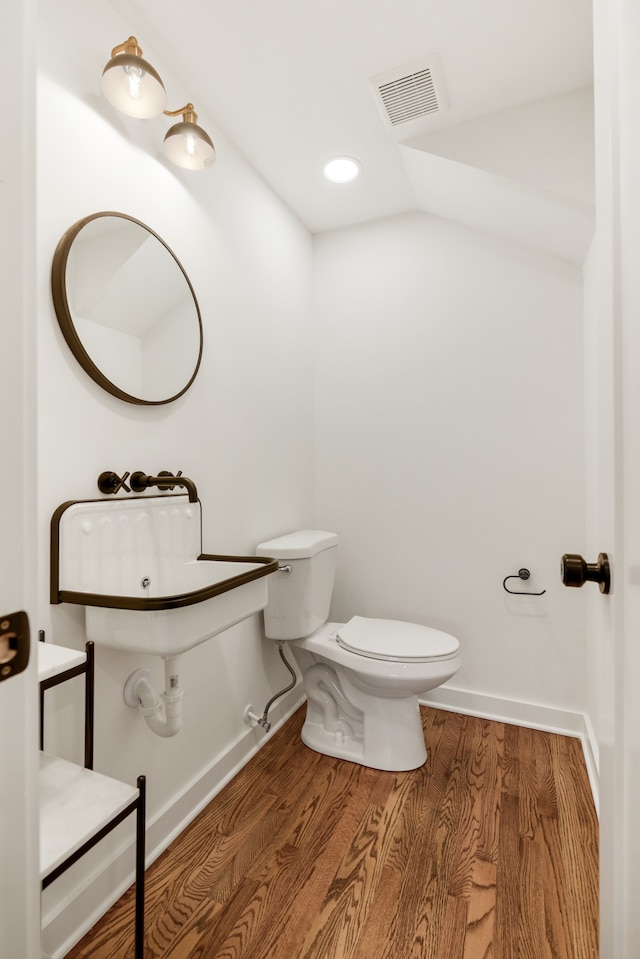 bathroom with toilet and wood-type flooring