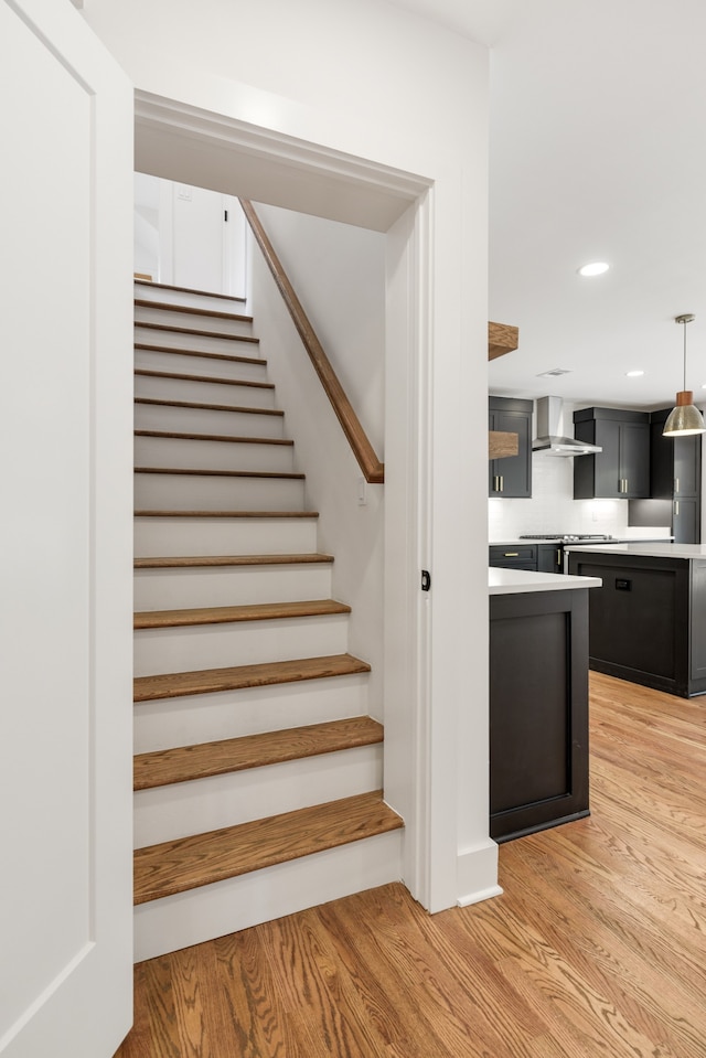 stairs with light hardwood / wood-style floors