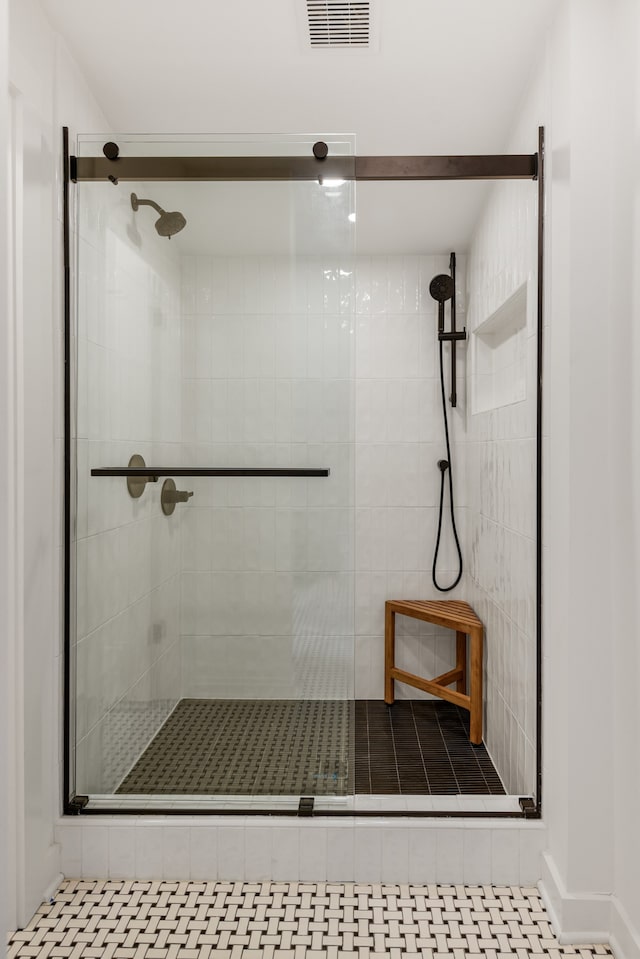 bathroom featuring tile flooring and a shower with door