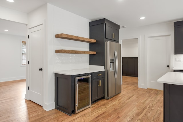 kitchen featuring backsplash, wine cooler, light wood-type flooring, and stainless steel refrigerator with ice dispenser