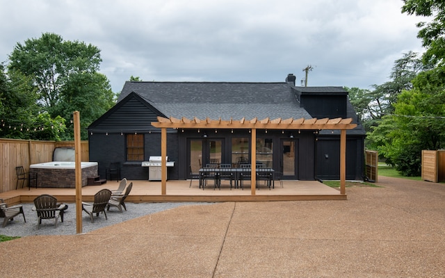 rear view of property with a fire pit, a pergola, and a patio