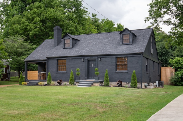 view of front facade featuring a front yard and central AC