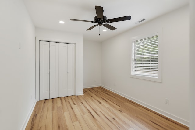 unfurnished bedroom featuring a closet, ceiling fan, and light wood-type flooring