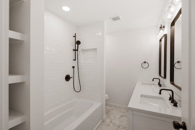 full bathroom with tiled shower / bath combo, double sink vanity, tile floors, and toilet