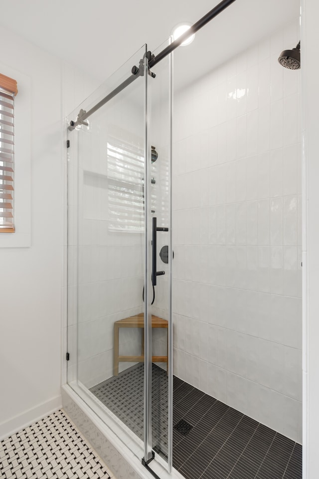 bathroom featuring tile flooring and a shower with shower door