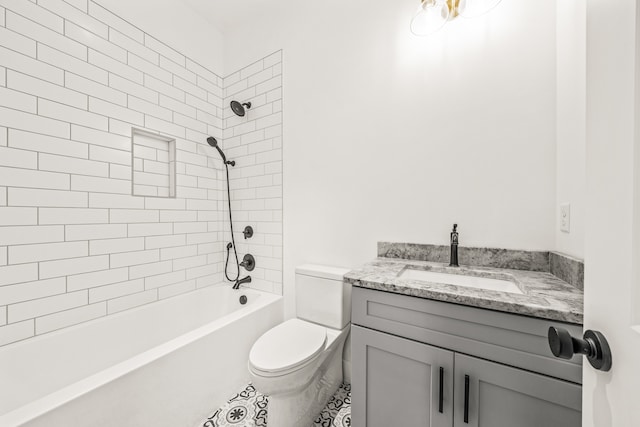 full bathroom with vanity, tile floors, toilet, and tiled shower / bath