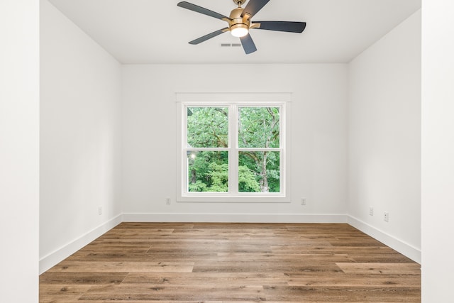 spare room featuring ceiling fan and light wood-type flooring