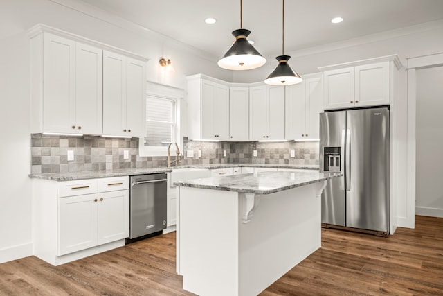 kitchen with dark hardwood / wood-style flooring, stainless steel appliances, backsplash, and a center island