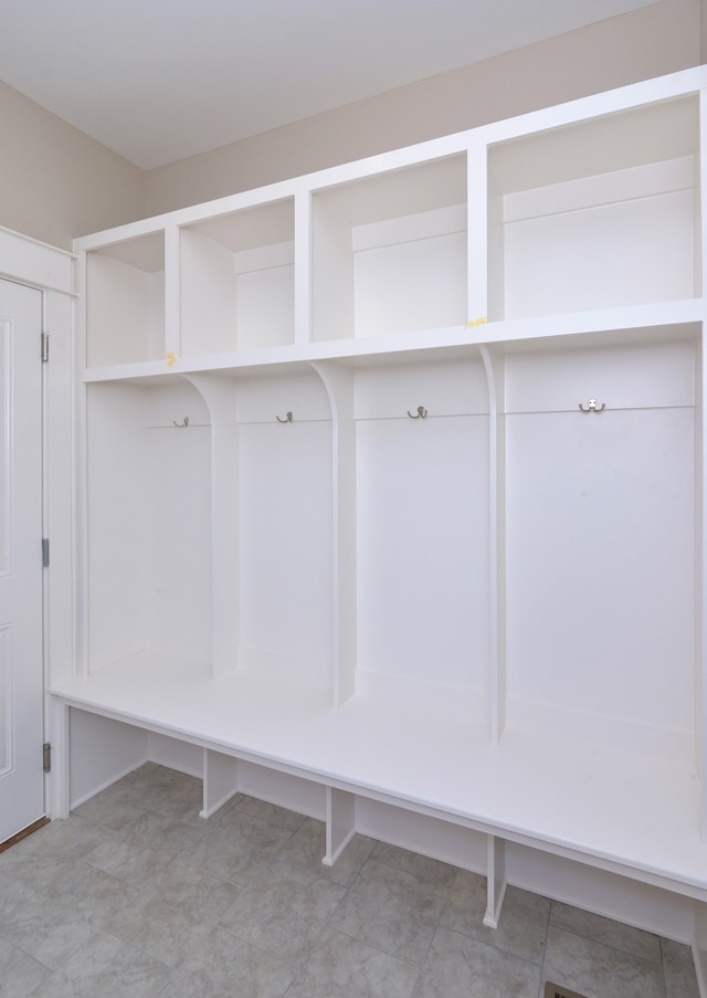 mudroom featuring light tile floors