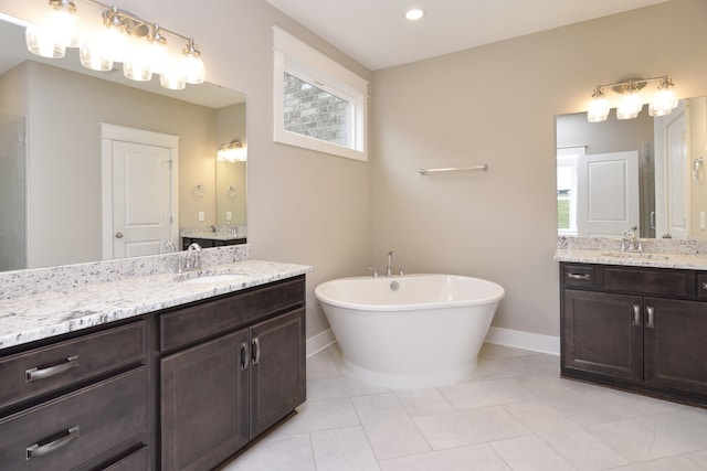 bathroom with dual vanity, tile floors, and a bathing tub