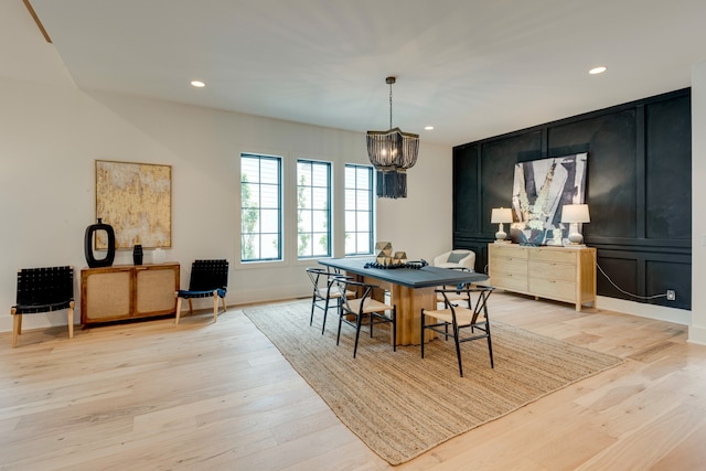 dining space featuring an inviting chandelier and light hardwood / wood-style floors