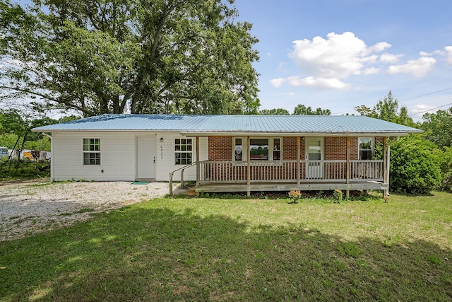 ranch-style home with covered porch and a front lawn