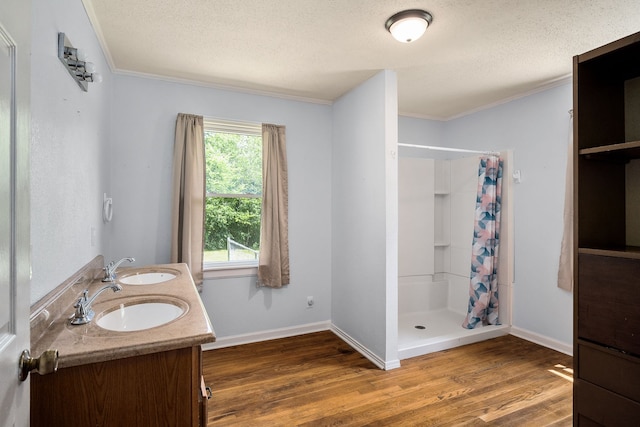 bathroom featuring a shower with curtain, double sink vanity, hardwood / wood-style flooring, and plenty of natural light