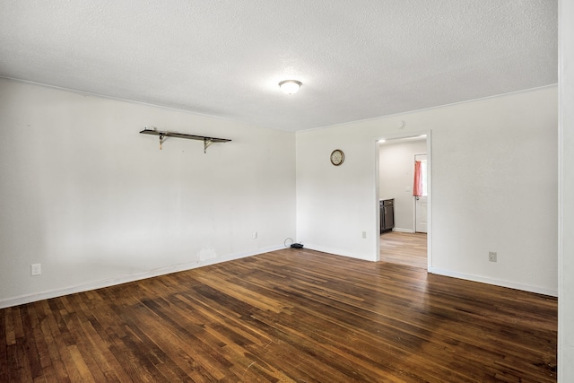 unfurnished room featuring a textured ceiling and dark hardwood / wood-style flooring