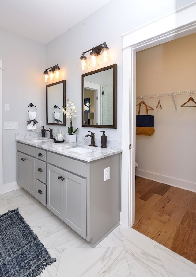 bathroom featuring double sink, tile floors, and vanity with extensive cabinet space