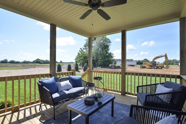 wooden deck featuring ceiling fan, an outdoor hangout area, and a lawn