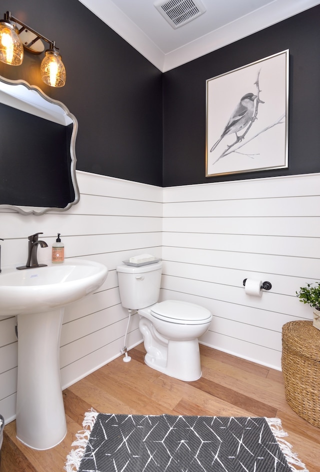 bathroom featuring hardwood / wood-style floors and toilet