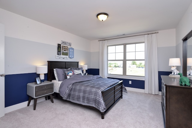 bedroom featuring light carpet