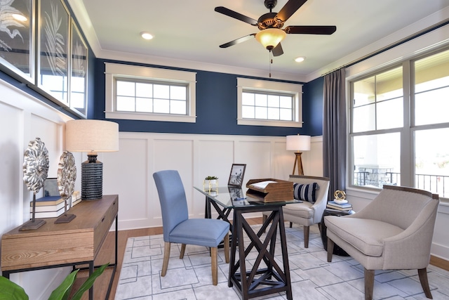 living area with plenty of natural light, crown molding, and ceiling fan