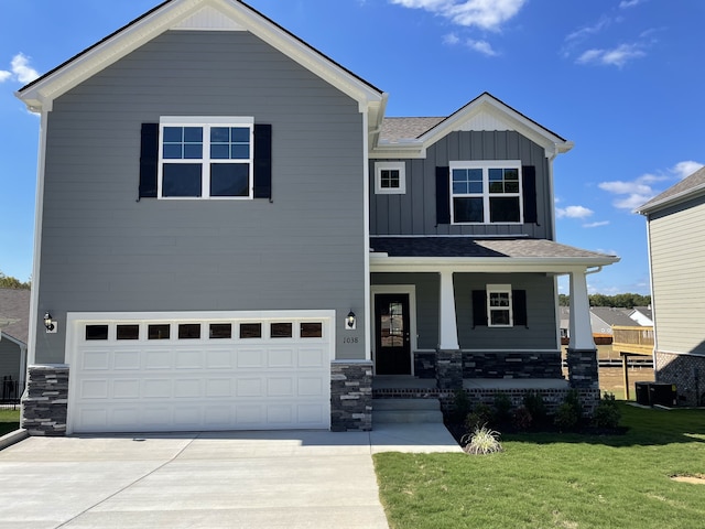 1030 Wiseman Farm Rd, Fairview, TN 37062 - view of front of property with covered porch, a front yard, and a garage