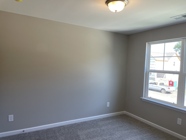 empty room featuring dark colored carpet