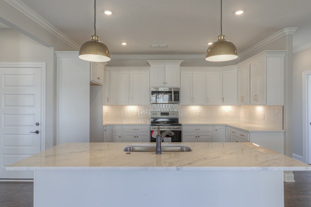 kitchen featuring hanging light fixtures, stainless steel appliances, and white cabinetry