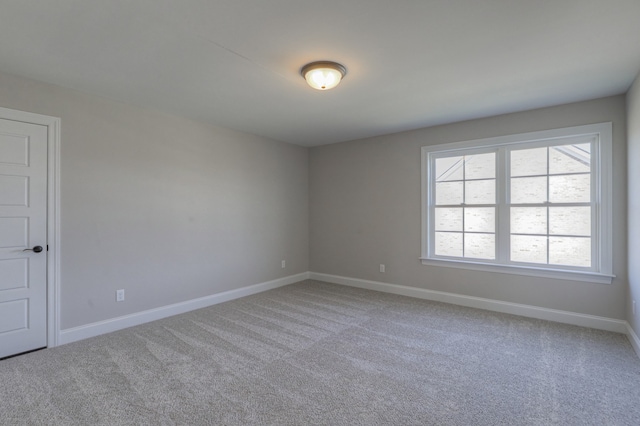 spare room featuring light colored carpet