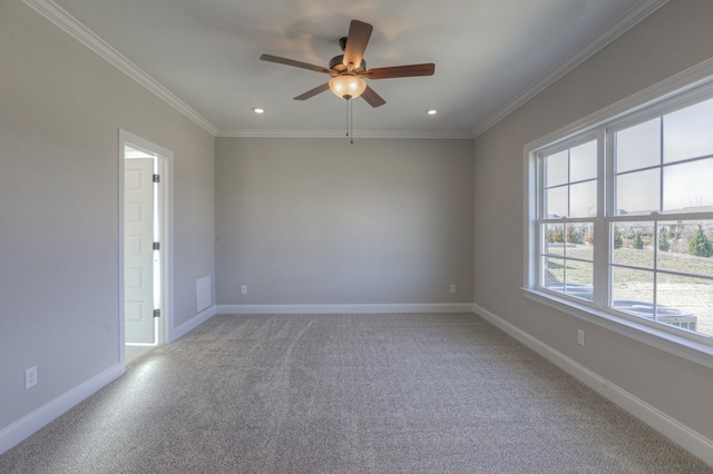 empty room featuring crown molding, ceiling fan, and light colored carpet