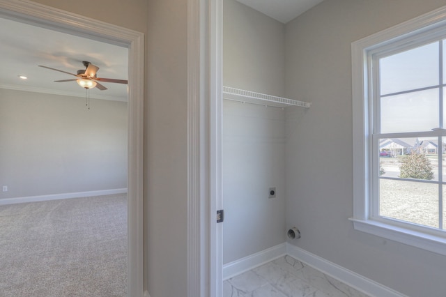 washroom with ceiling fan, light colored carpet, ornamental molding, and hookup for an electric dryer