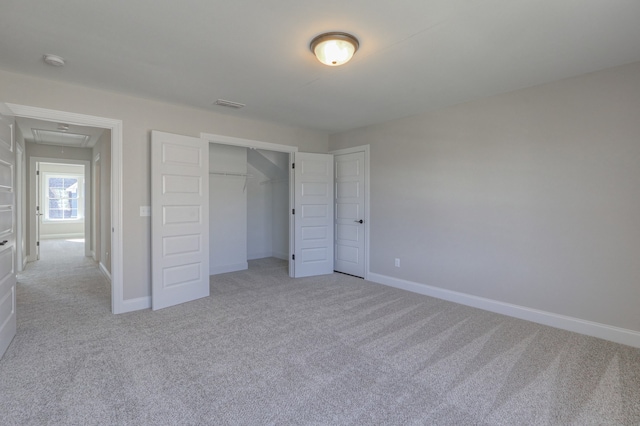 unfurnished bedroom featuring a closet and light colored carpet