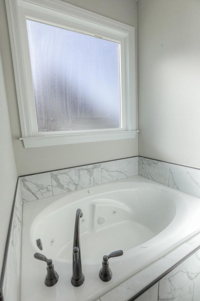 bathroom with a relaxing tiled bath