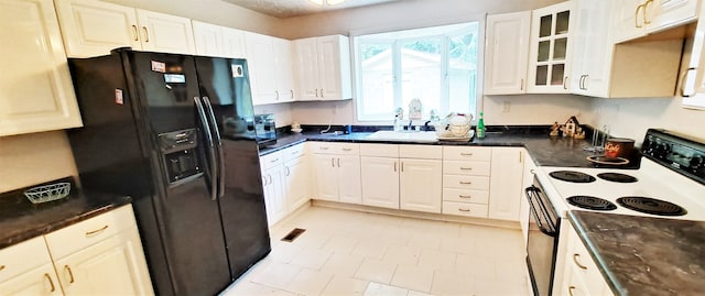 kitchen with light tile flooring, black refrigerator with ice dispenser, white cabinets, and electric range