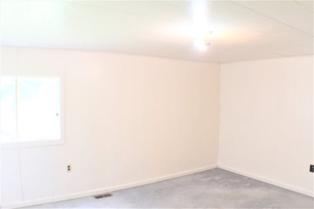 unfurnished room with light carpet